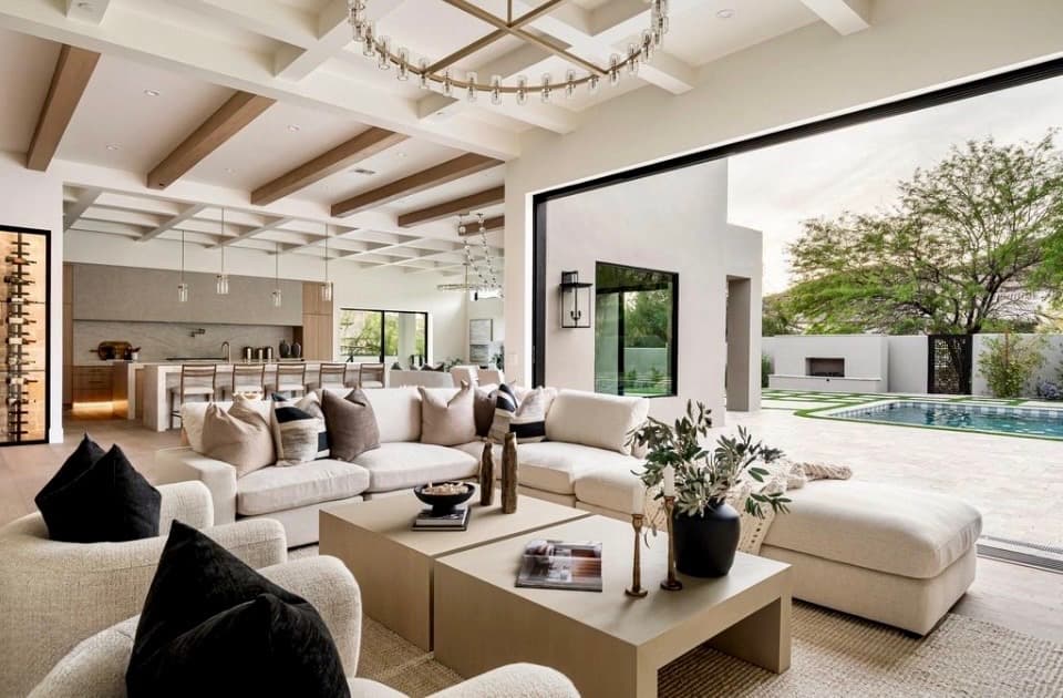 Open-plan great room and kitchen with accordion doors to outdoor pool